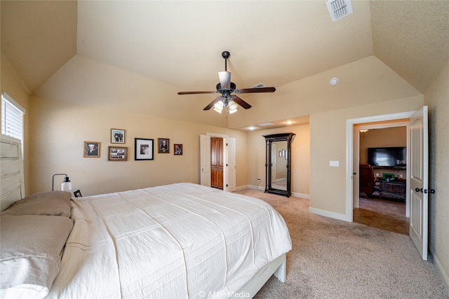 carpeted bedroom with ceiling fan and vaulted ceiling