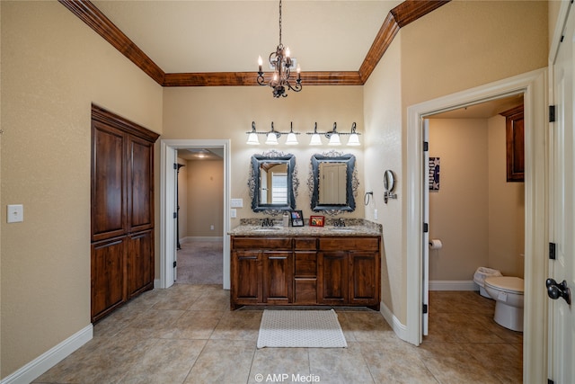 bathroom with vanity, toilet, ornamental molding, and tile patterned flooring