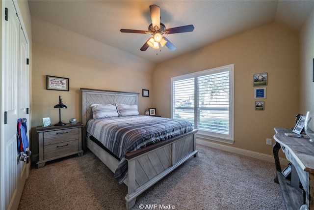 bedroom featuring lofted ceiling, dark carpet, and ceiling fan