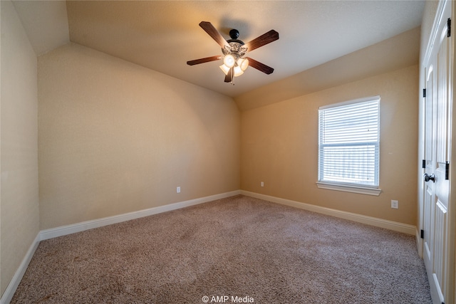 carpeted spare room with lofted ceiling and ceiling fan