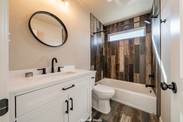 full bathroom featuring vanity, toilet, tiled shower / bath combo, and hardwood / wood-style floors