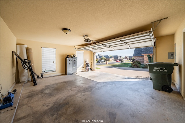 garage featuring a garage door opener and water heater