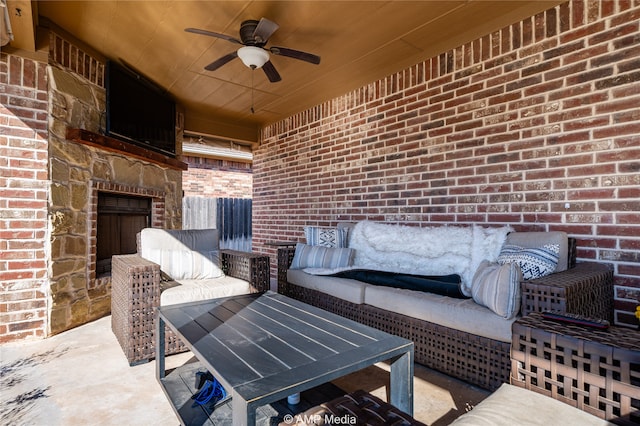 view of patio / terrace with ceiling fan and an outdoor stone fireplace