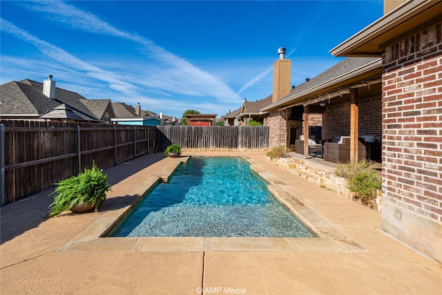 view of swimming pool with a patio area