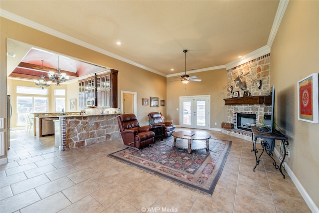 tiled living room featuring french doors, a fireplace, crown molding, and plenty of natural light