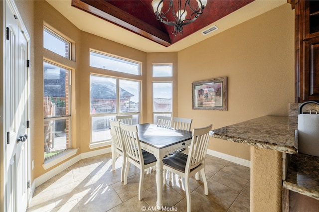 dining room featuring light tile patterned flooring and an inviting chandelier