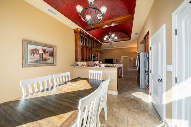 dining room with lofted ceiling, crown molding, light tile patterned flooring, a notable chandelier, and sink