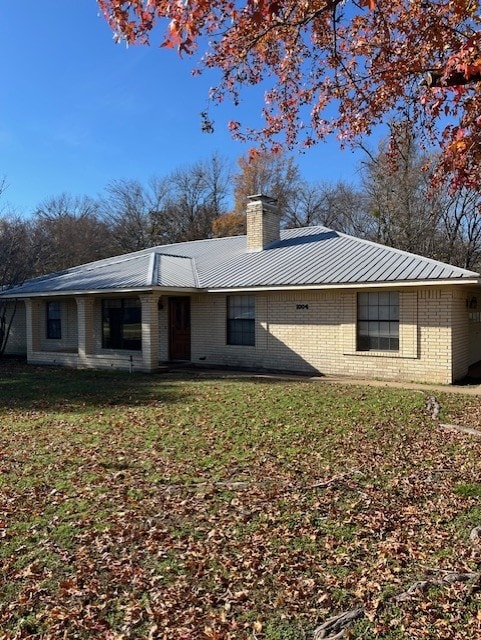 rear view of property with a lawn