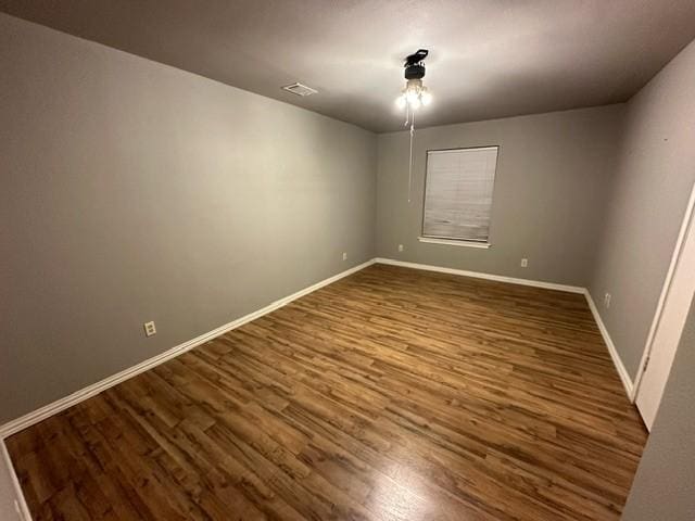 unfurnished room featuring dark wood-type flooring