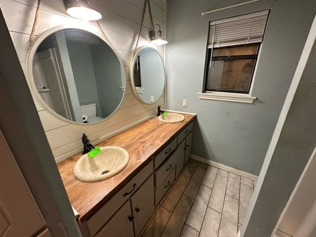 bathroom featuring vanity and toilet