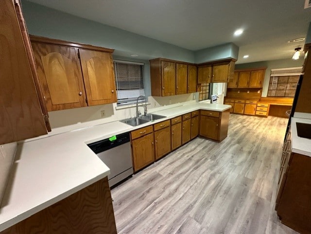 kitchen with white refrigerator, light hardwood / wood-style flooring, stainless steel dishwasher, and sink