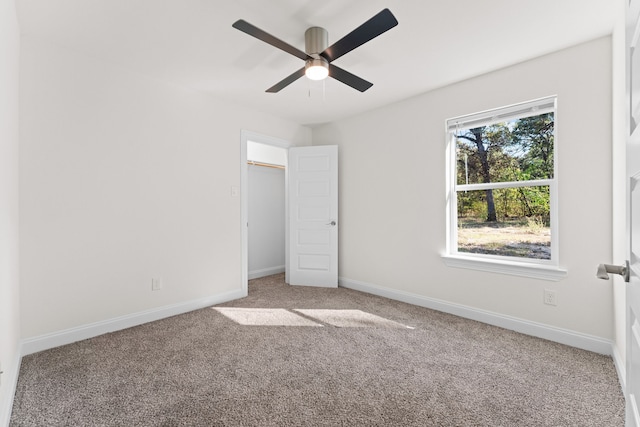 unfurnished bedroom featuring carpet floors, a closet, and ceiling fan