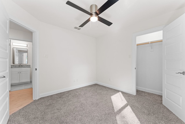 unfurnished bedroom featuring light carpet, a closet, and ceiling fan