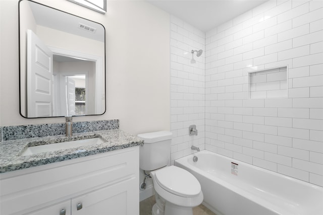 full bathroom featuring vanity, toilet, and tiled shower / bath