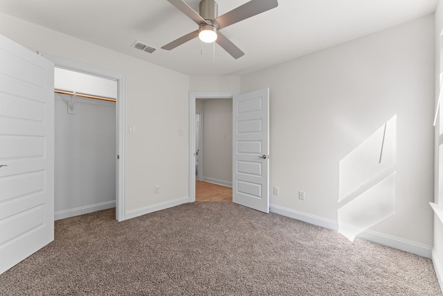 unfurnished bedroom with a closet, carpet floors, and ceiling fan