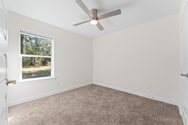 empty room with ceiling fan and carpet