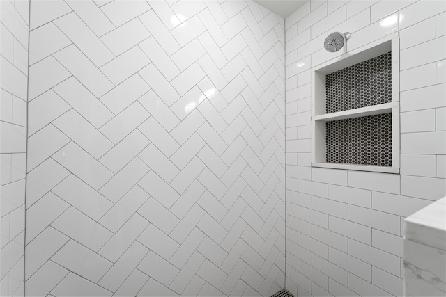 bathroom with tiled shower