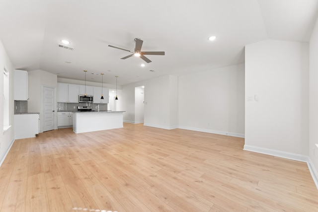 unfurnished living room featuring light hardwood / wood-style floors and ceiling fan