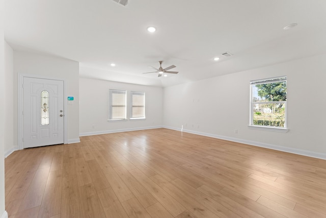 interior space with light hardwood / wood-style flooring and ceiling fan