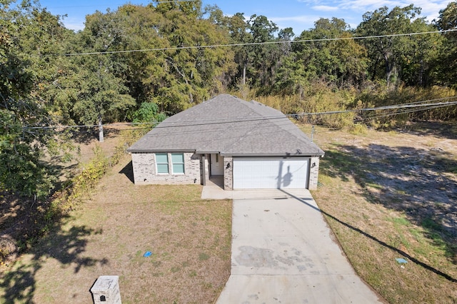 view of front of house with a front yard and a garage