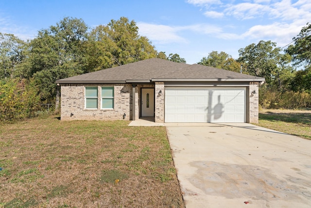 single story home with a front yard and a garage