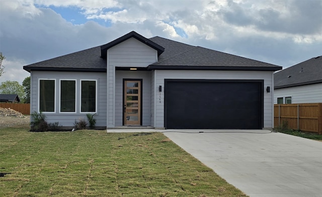 view of front of home featuring a garage and a front lawn