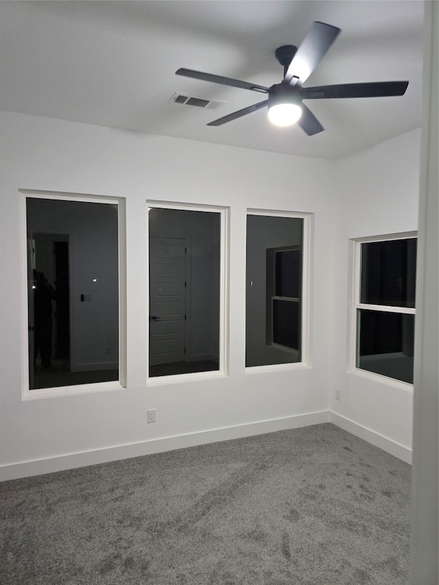 unfurnished room with carpet flooring and ceiling fan