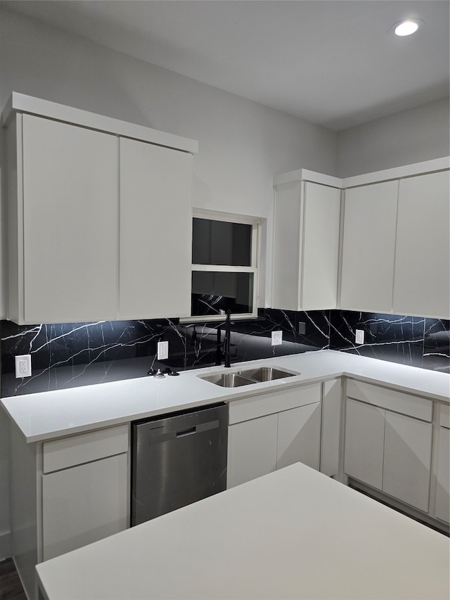 kitchen with white cabinetry, sink, and stainless steel dishwasher