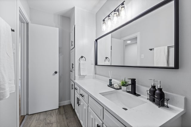 bathroom with vanity and wood-type flooring