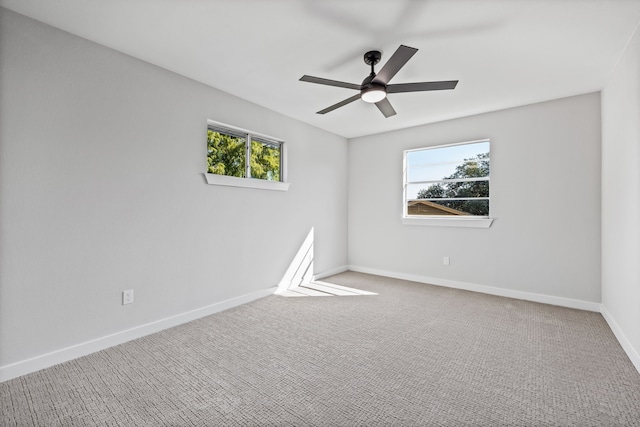 carpeted spare room featuring ceiling fan