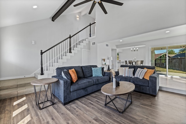 living room featuring beamed ceiling, hardwood / wood-style floors, high vaulted ceiling, and ceiling fan with notable chandelier