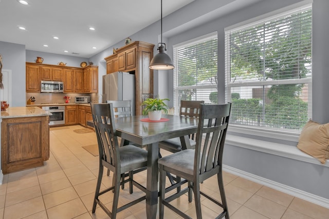 tiled dining room with a healthy amount of sunlight