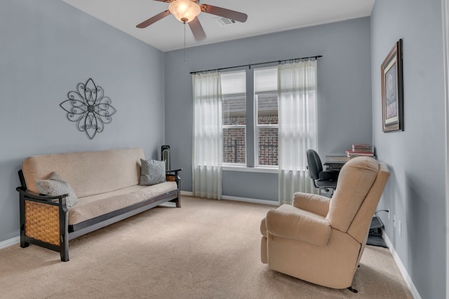 sitting room featuring light carpet and ceiling fan