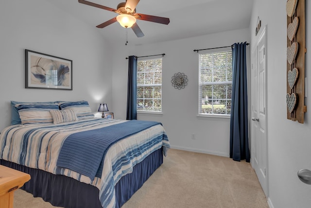 carpeted bedroom with lofted ceiling and ceiling fan