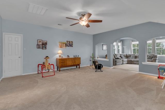 sitting room with light carpet, vaulted ceiling, and ceiling fan