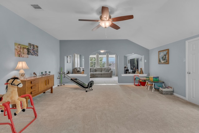 interior space featuring vaulted ceiling, light carpet, and ceiling fan