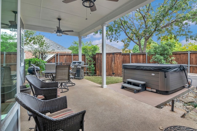 view of patio / terrace with a hot tub, area for grilling, and ceiling fan