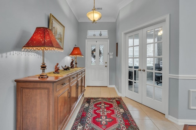 tiled entrance foyer featuring french doors and crown molding