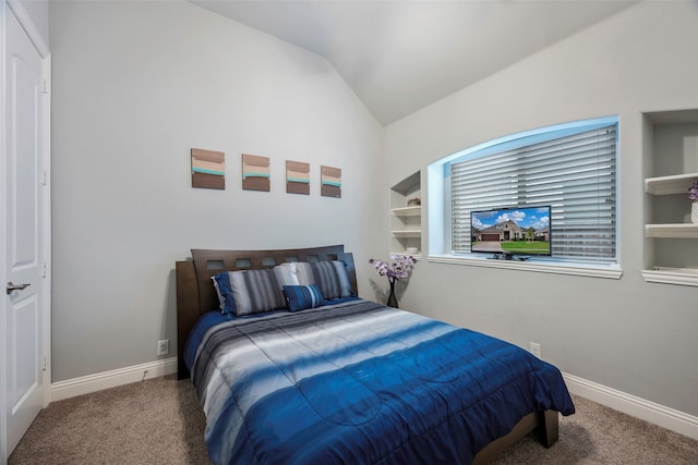 carpeted bedroom with vaulted ceiling