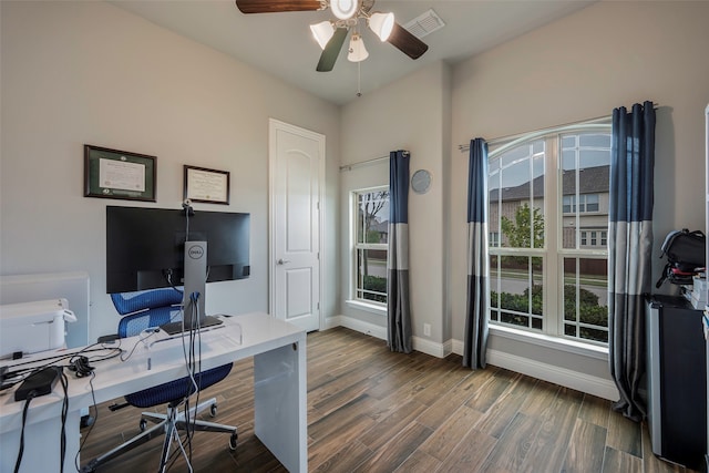 home office with dark hardwood / wood-style floors and ceiling fan