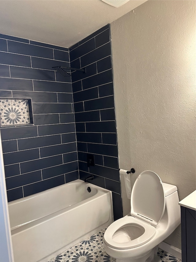 full bathroom featuring vanity, toilet, tile patterned flooring, and tiled shower / bath