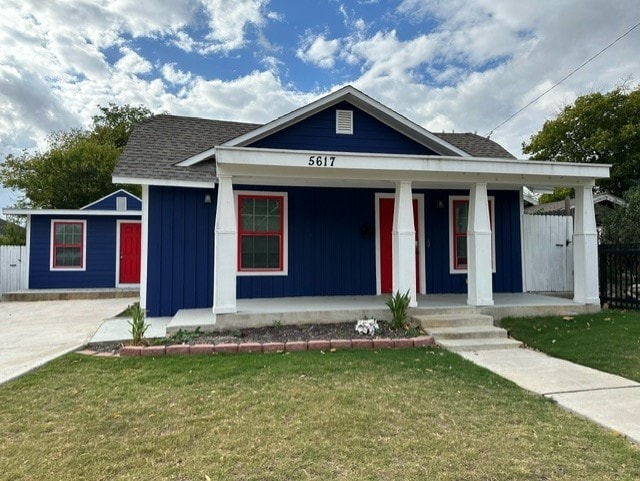 view of front facade with a front yard and a porch