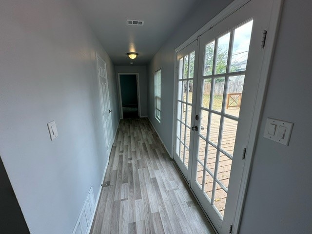 hall with light hardwood / wood-style flooring