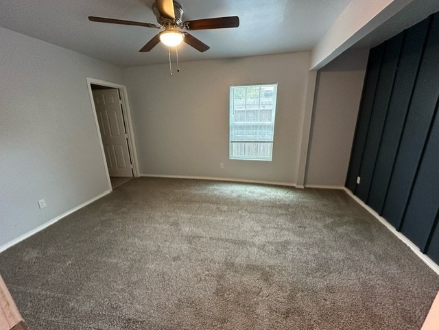 empty room featuring carpet floors and ceiling fan