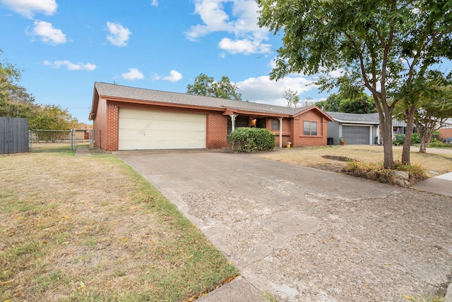 ranch-style house with a garage and a front lawn