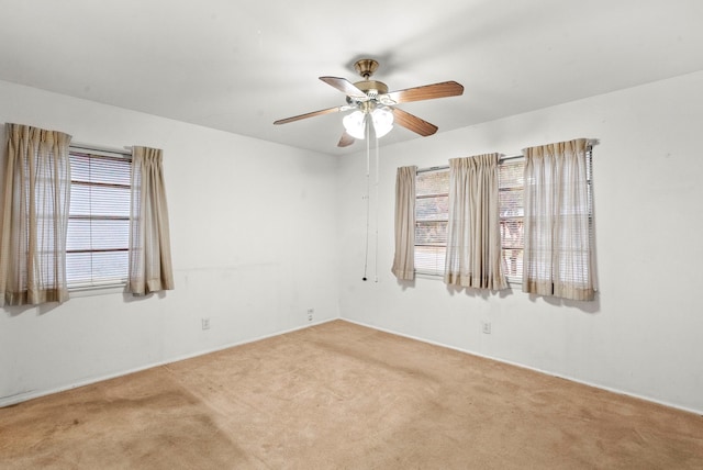 carpeted empty room featuring ceiling fan