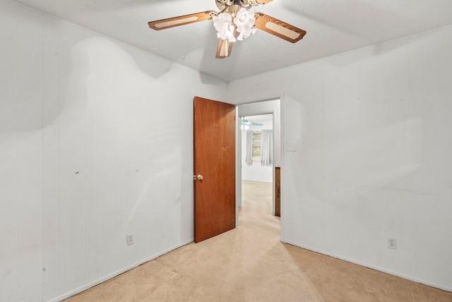 empty room with ceiling fan and light carpet