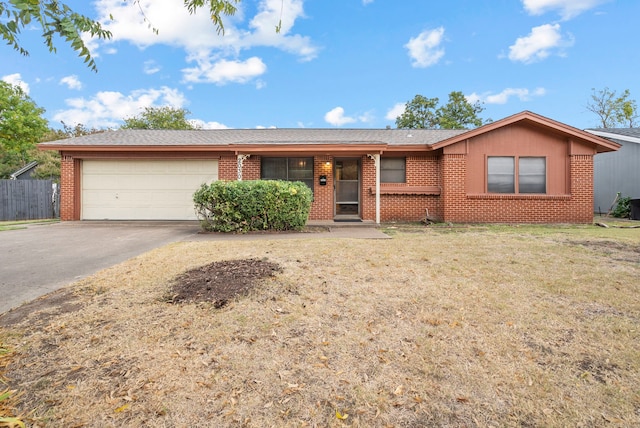 single story home featuring a front lawn and a garage