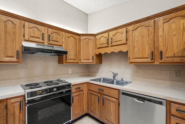 kitchen featuring a textured ceiling, stainless steel appliances, and sink