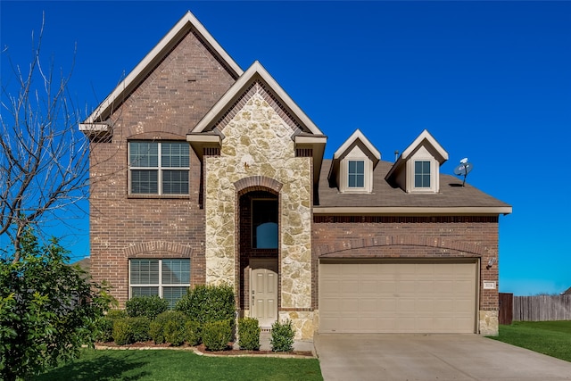 view of front of property with a front yard and a garage